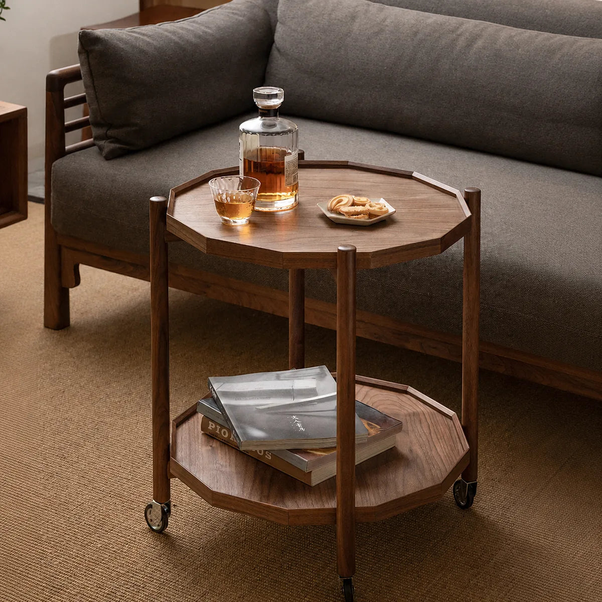 Twelve-sided walnut rolling side table beside a sofa