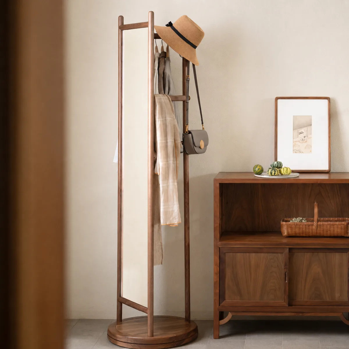 Black walnut rotating mirror garment rack with clothing and accessories