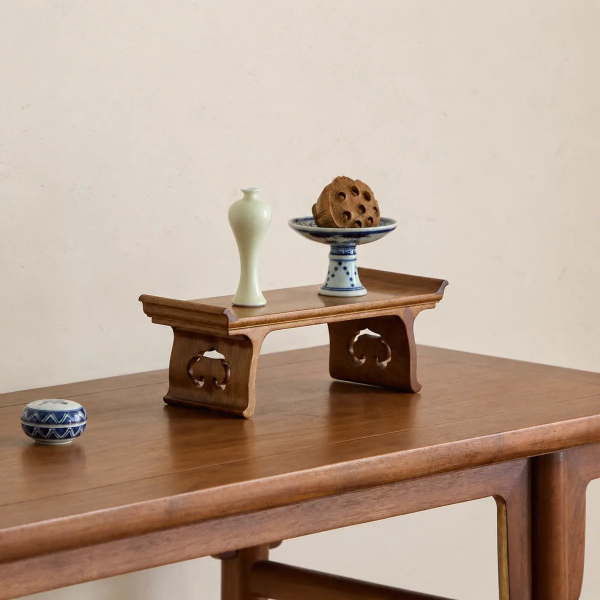 Golden Phoebe wood Ruyi display stand styled with ceramic objects
