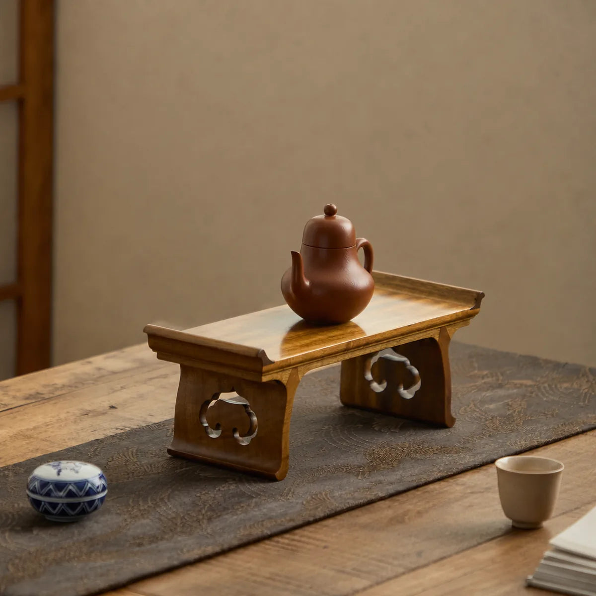 Golden Phoebe Ruyi stand in a traditional tea setting