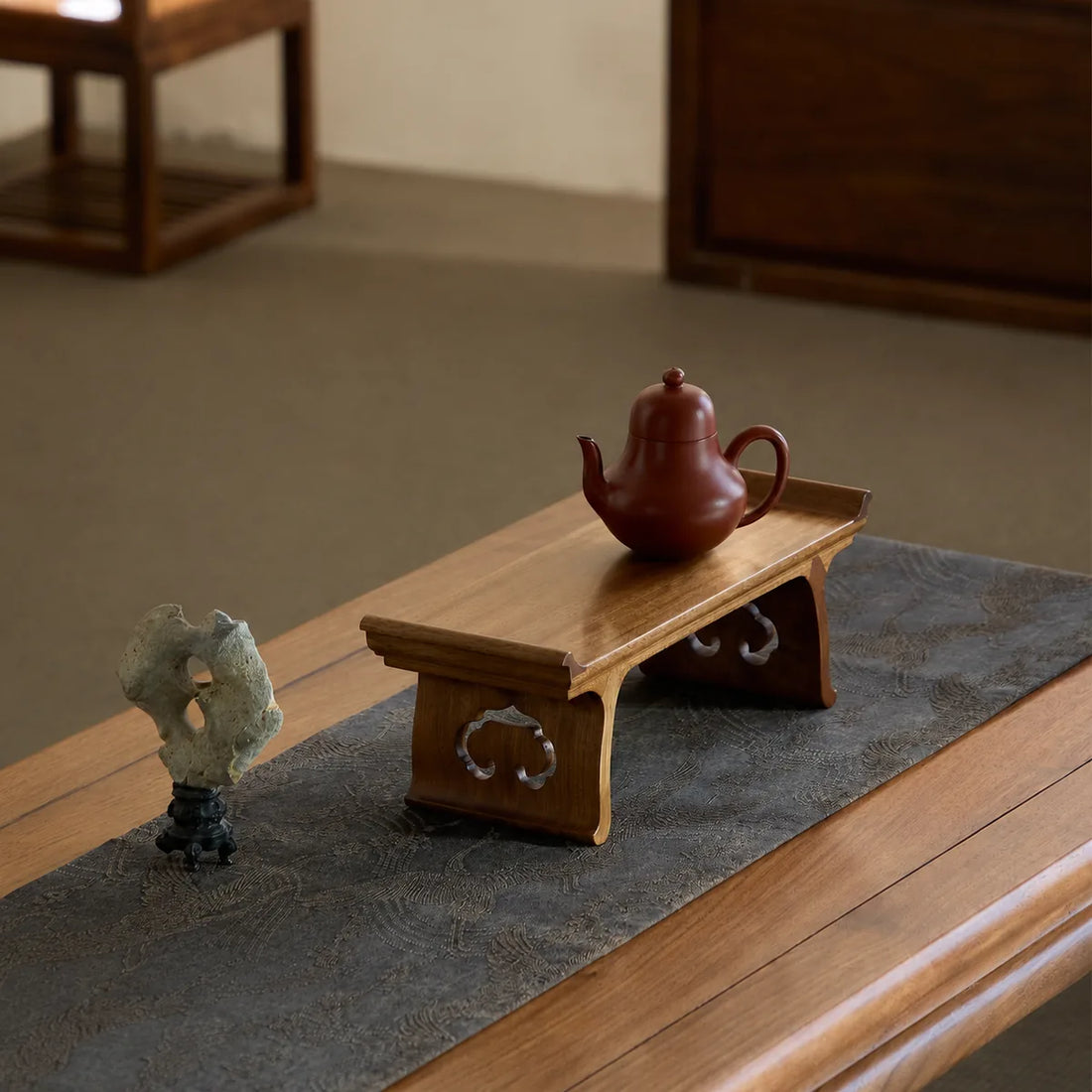 Handcrafted Golden Phoebe wood Ruyi display stand with celadon and blue-and-white objects