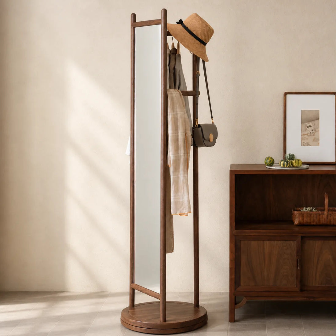 Black walnut 360-degree rotating mirror garment rack in a warm interior