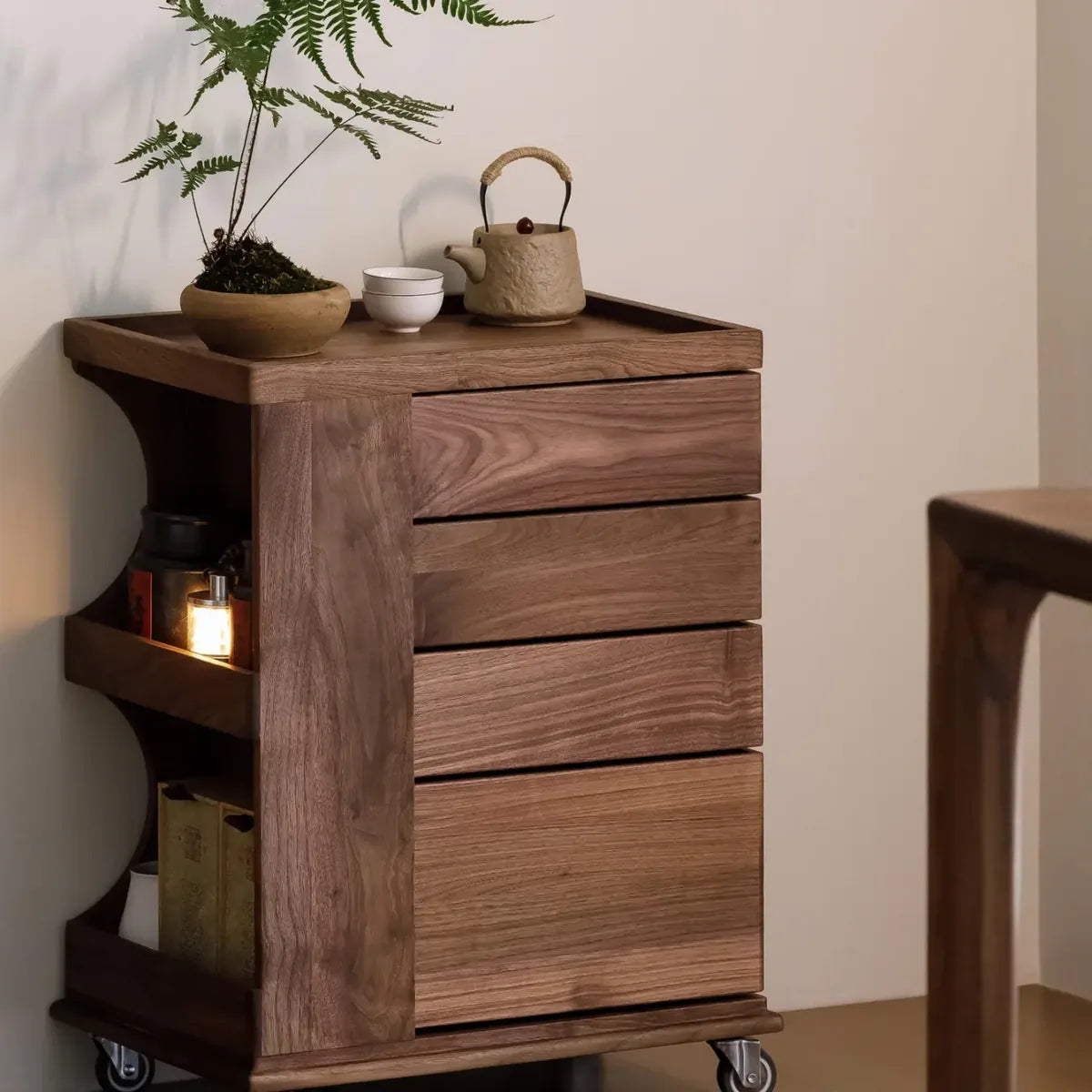 Walnut rolling cabinet styled beside a wall